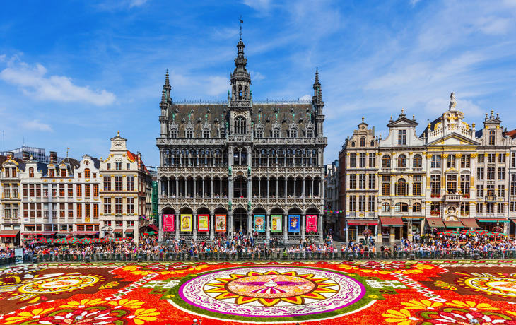 Blumenteppich auf dem Grand Place in Brüssel, umgeben von historischen Gebäuden.